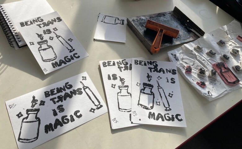 "Being Trans is Magic", a handmade linocut print design.